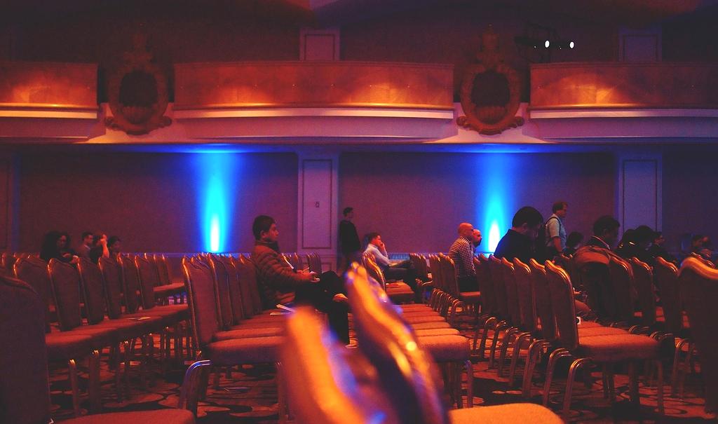 Ethereal theater space where collective memories manifest as living stories around seated audience